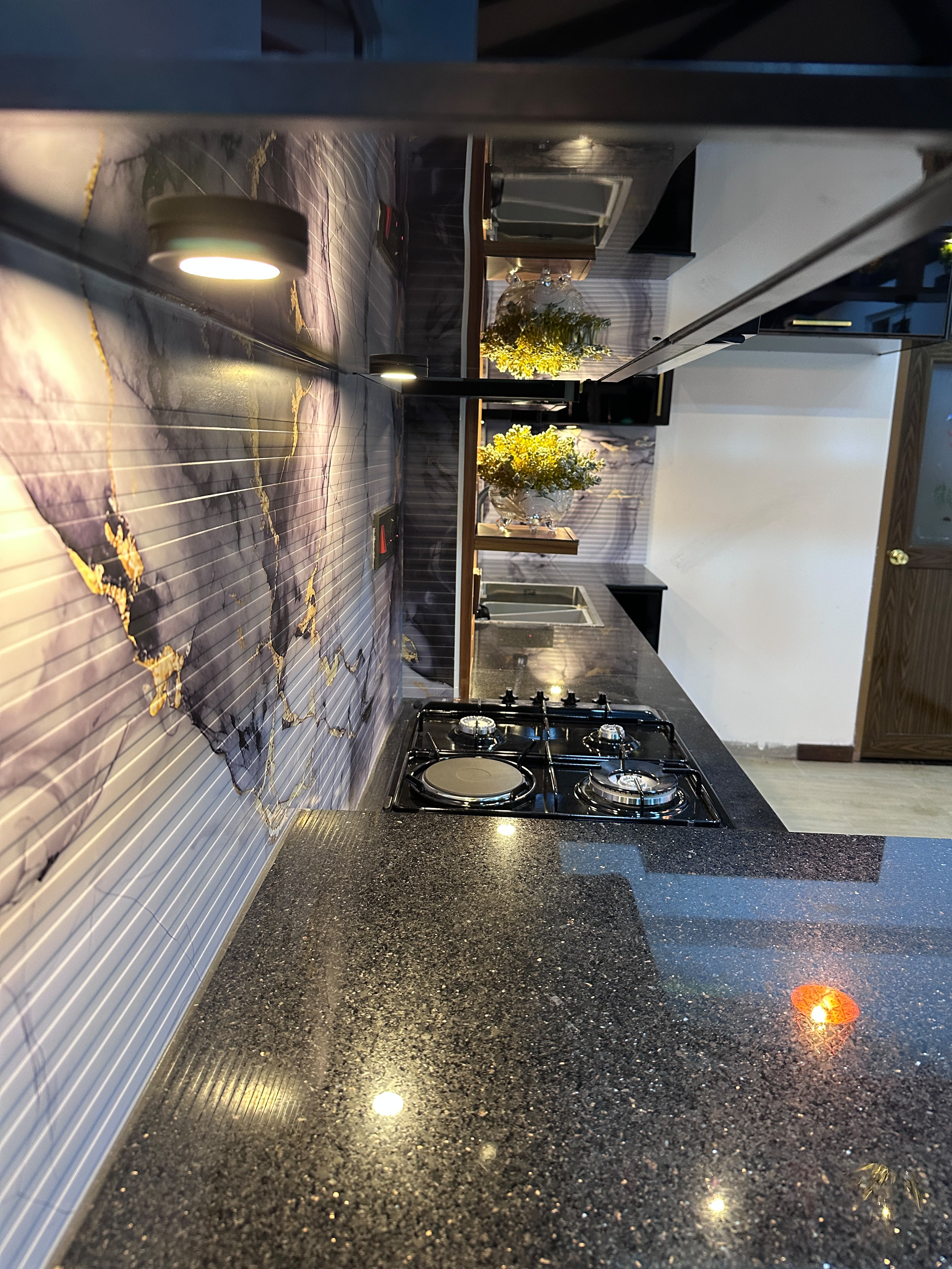 Premium kitchen countertop with marble backsplash and hob